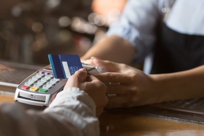 Female Customer Holding Credit Card Near Nfc Technology On Counter